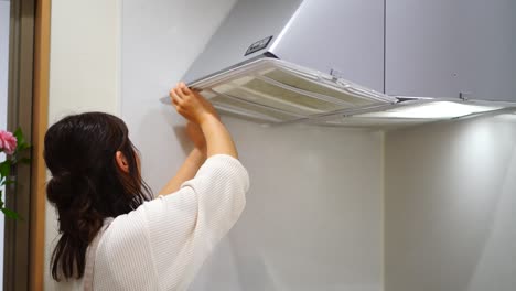 woman installing a ventilator filter