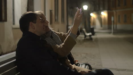 happy couple making selfie in evening street