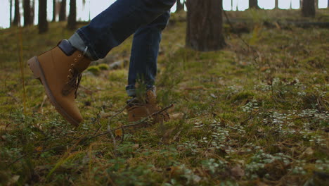 Person-is-walking-in-a-forest.-Close-up-focus-on-boot-or-hiking-shoes.-Close-up-view-of-man-legs-walking-in-the-summer-forest.-Man-hiking-on-a-forest-trail.-High-quality-4k-footage