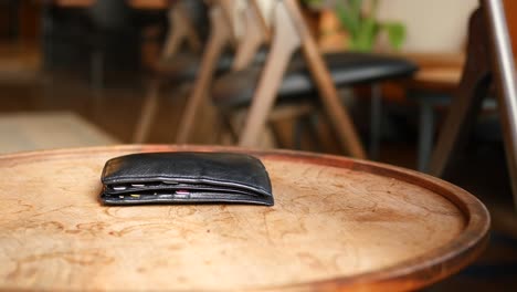 black wallet on a wooden table