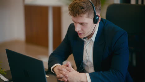 manager discussing on video call in office.