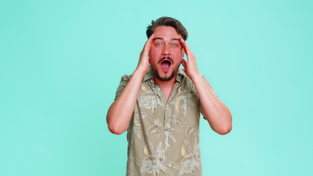 Adult man opens mouth shocked by unexpected win or success showing wow emotion with amazed reaction