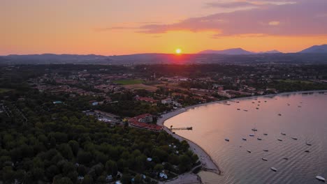 aerial viw of a perfect idyllic sunset above lago di garda and salo city, italy