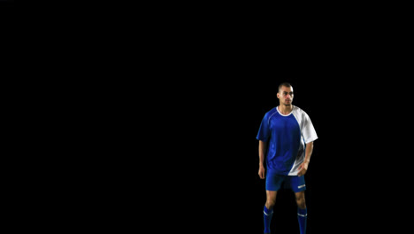 Athlete-practicing-soccer-against-black-background