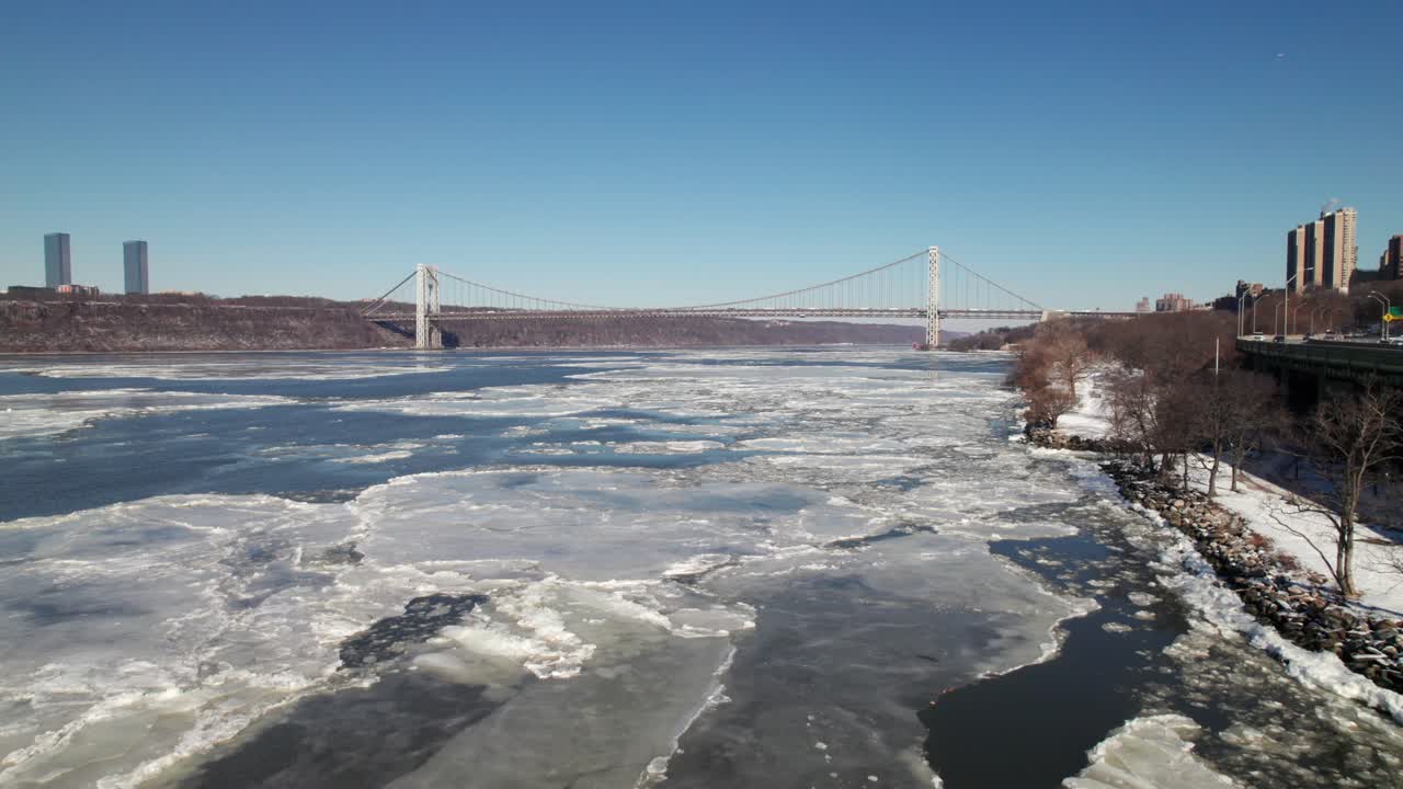 Hudson River in winter, covered with icebergs, George Washington Bridge, 4K aerial