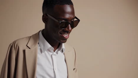 stylish african american man in blazer and sunglasses