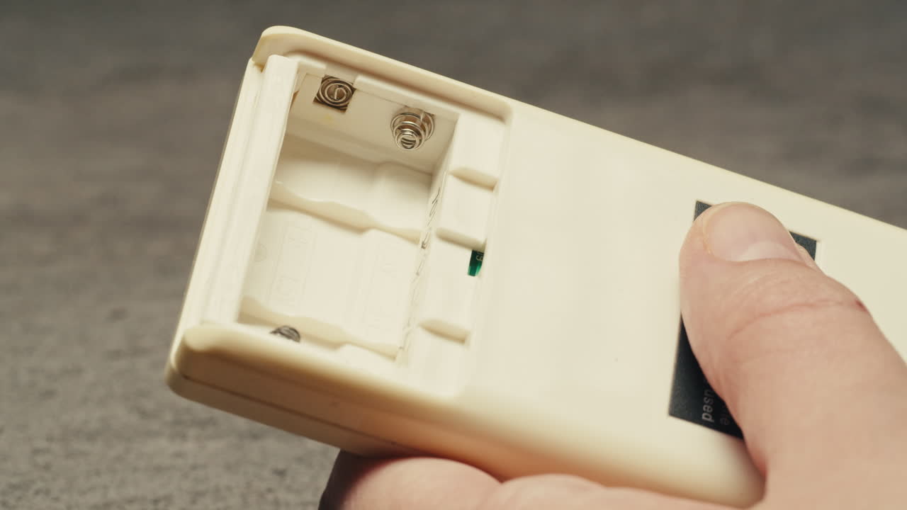 Adding silver batteries AA and AAA in remote controller TV close-up. Batteries are common in portable electronic devices. An AA battery is composed of a single electrochemical cell that may be either a primary battery or a rechargeable battery. Several different chemistries are used in their constru