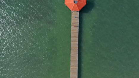 Top-down-aerial-view-of-wooden-pier-at-Playa-Juan-de-Bolanos,-Monte-Cristi