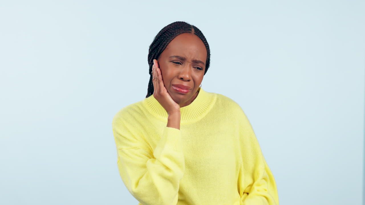 Toothache, pain and a woman in studio with hand
