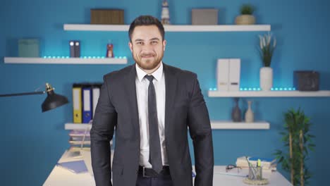 Businessman-smiling-at-camera-making-positive-sign.