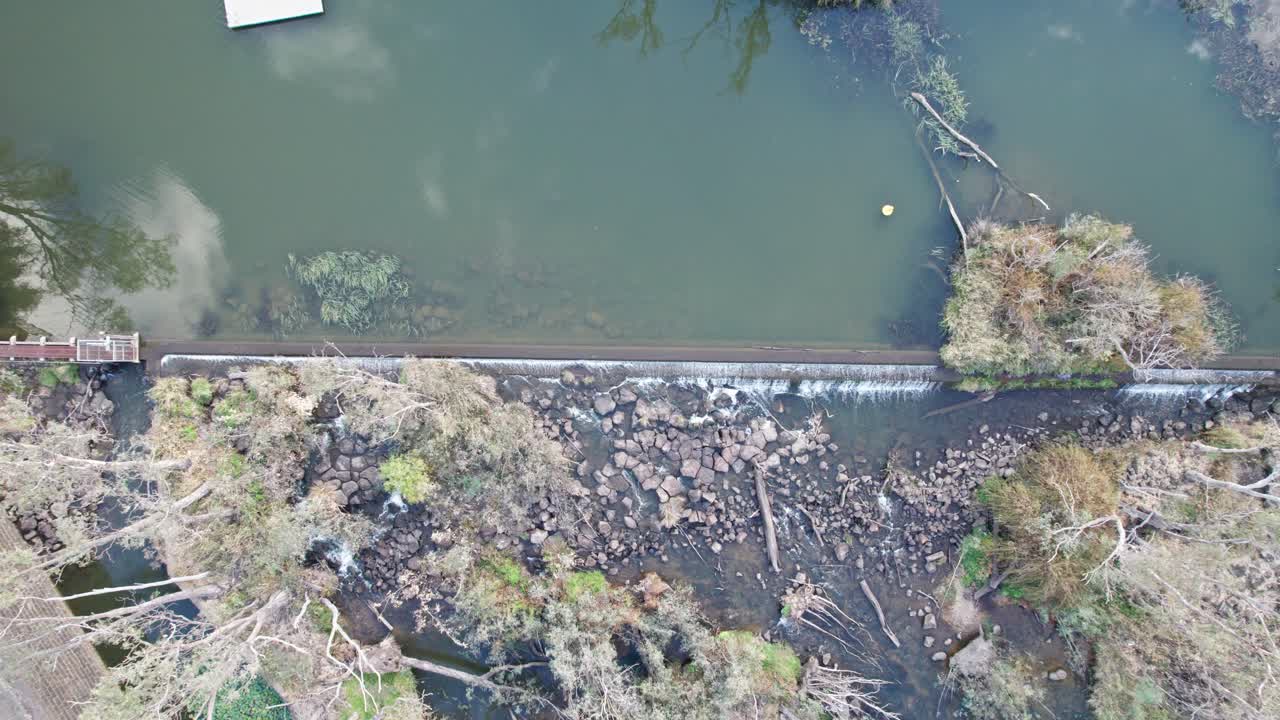 Zooming out drone view of the weir on the Loddon River at Bridgewater, then panning to show the countryside, central Victoria, Australia, May 2025.