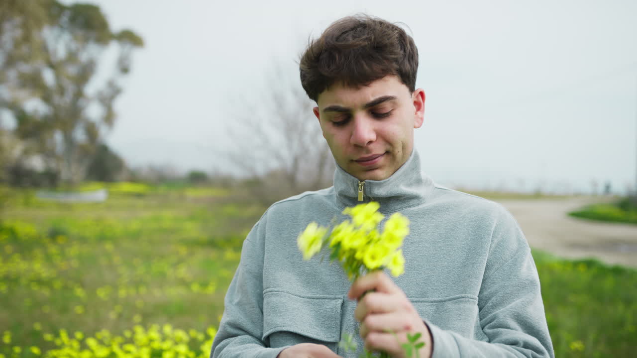 Man Selecting And Picking Yellow Flowers From The Ground