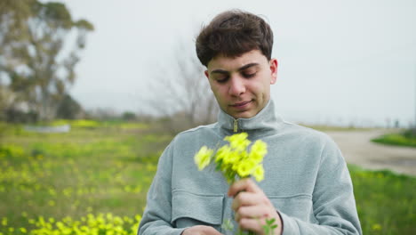man selecting and picking yellow flowers from the ground