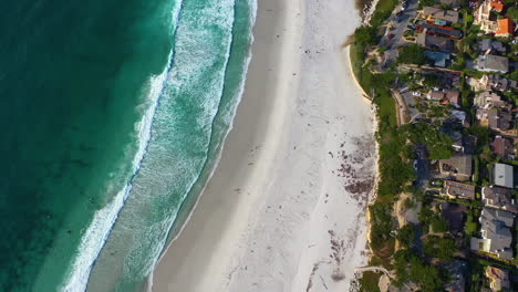 Aerial-view-rotating-above-waves-at-the-Carmel-beach,-sunset-in-Monterey,-USA