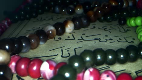 a page from the book of the holy quran and beads