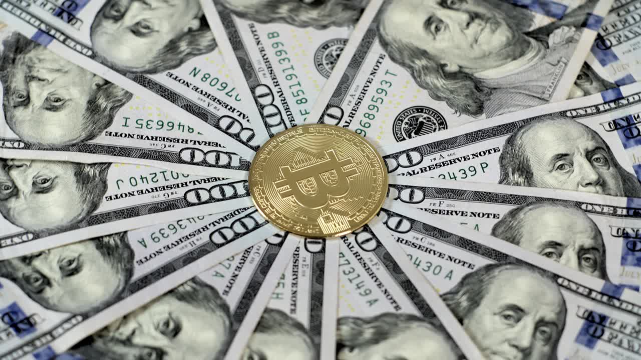 Golden Bitcoin Coin Surrounded by US One Hundred Dollar Bills