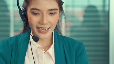 businesswoman wearing headset working actively in office