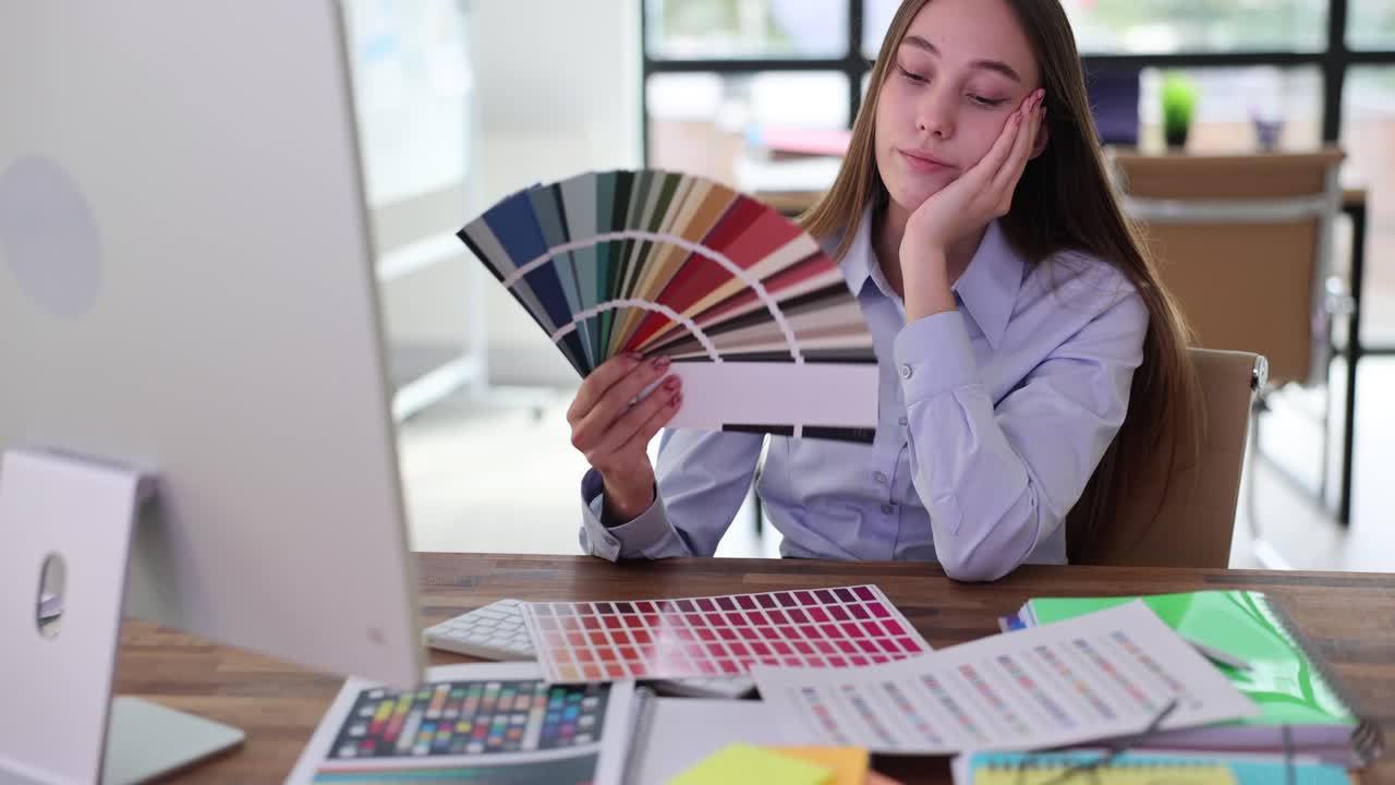 Young graphic designer working with color palettes