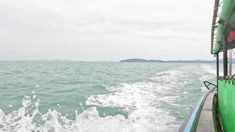 boat travels through ocean near krabi islands