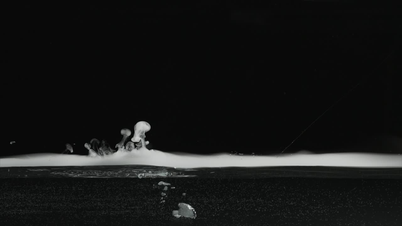 Slow motion dry ice fog-vapor floating on surface of water and bubbling in water. For use with visual effects and-or texturing and design.