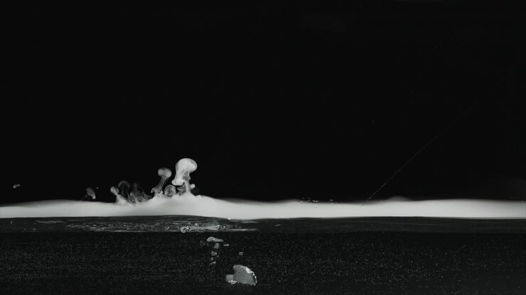 Slow motion dry ice fog-vapor floating on surface of water and bubbling in water. For use with visual effects and-or texturing and design.