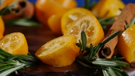 chocolate cake decorated with kumquats, cinnamon, and rosemary