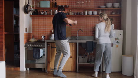 happy-young-couple-dancing-in-kitchen-enjoying-funny-dance-together-having-fun-celebrating-relationship-on-weekend-at-home