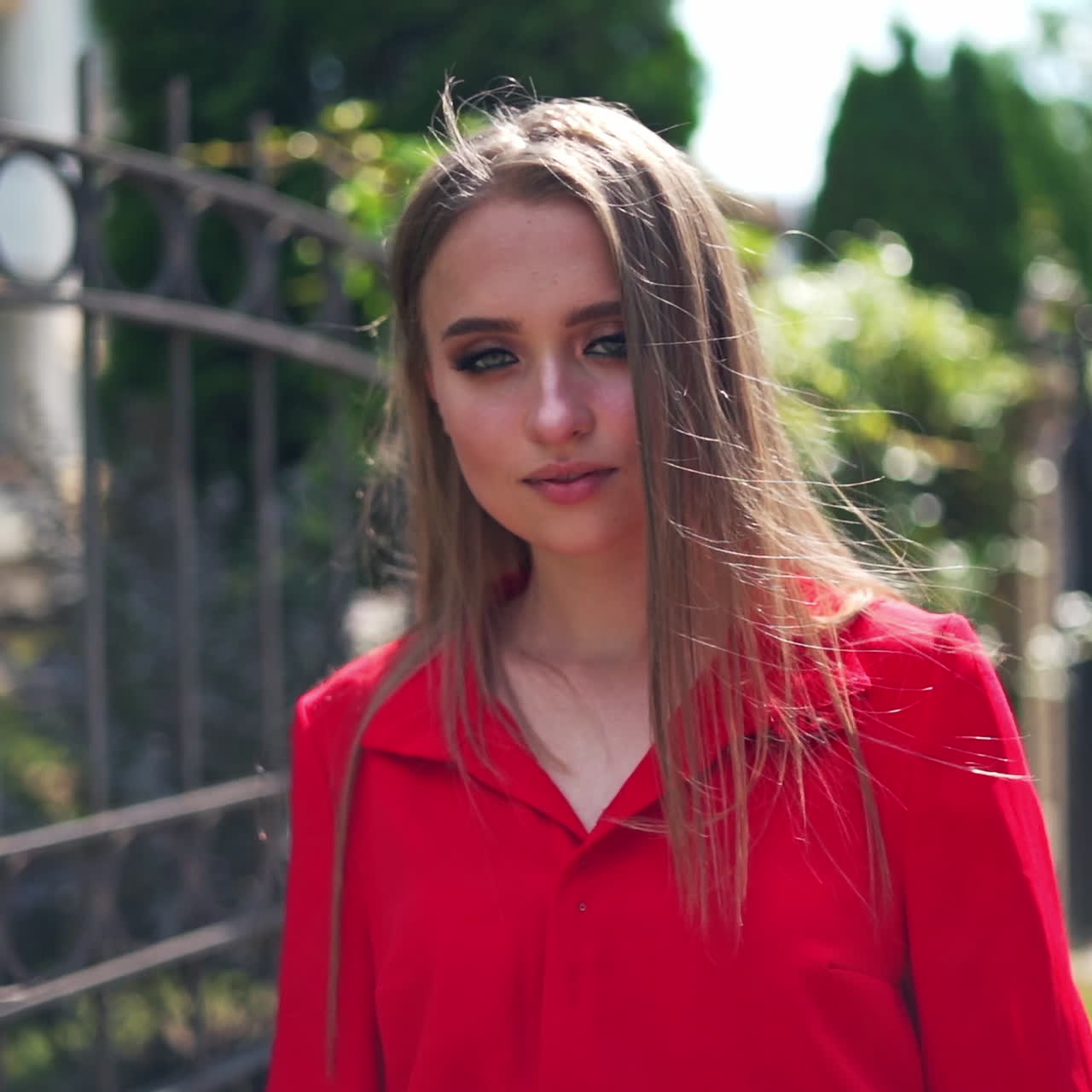 Portrait of attractive young female in summer. Beautiful woman with long hair turning around herself happily. Pretty woman walking along the street.