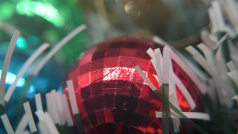 christmas decoration, colorful crystal ornaments golden, blue, green and red balls, new year decorated, shiny lights, cinematic close-up macro tilt up 4k video, beautiful depth of field, bokeh light