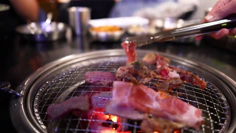 grilling pork and beef on a barbecue grill