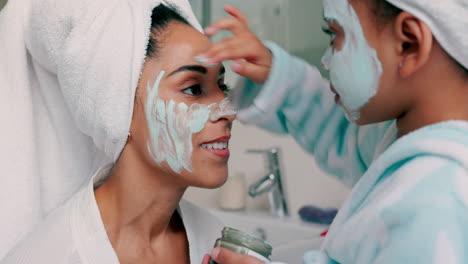 mother and daughter applying face masks