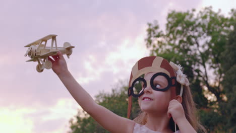 little girl playing with toy airplane