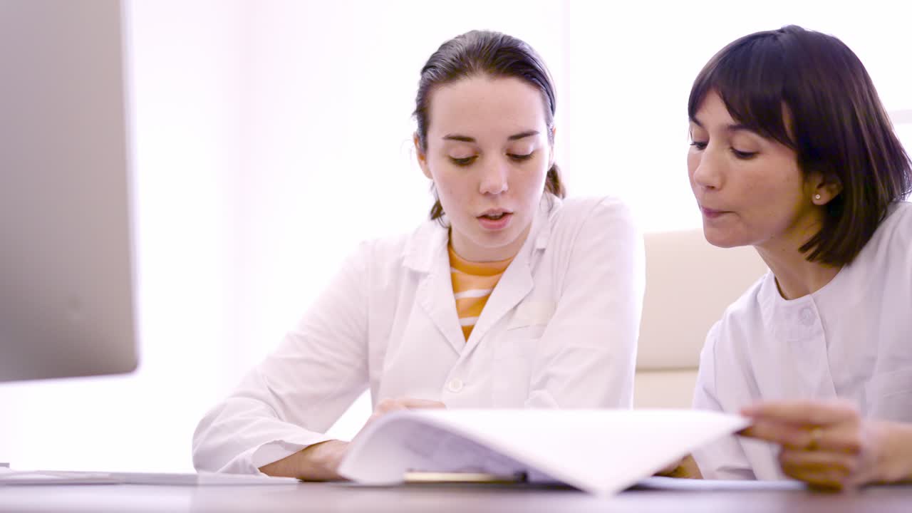 Two doctor consulting a medical inform in the clinic