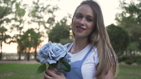 woman with a bouquet of blue roses