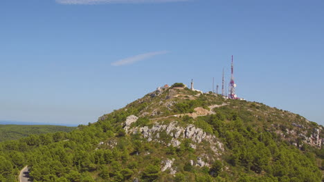 aerial view of monte toro on the spanish island of menorca with a car using the mountain road