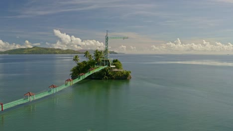 Point-of-view-aerial-over-Bacuag-Hanging-Bridge-and-Octopus-Islet