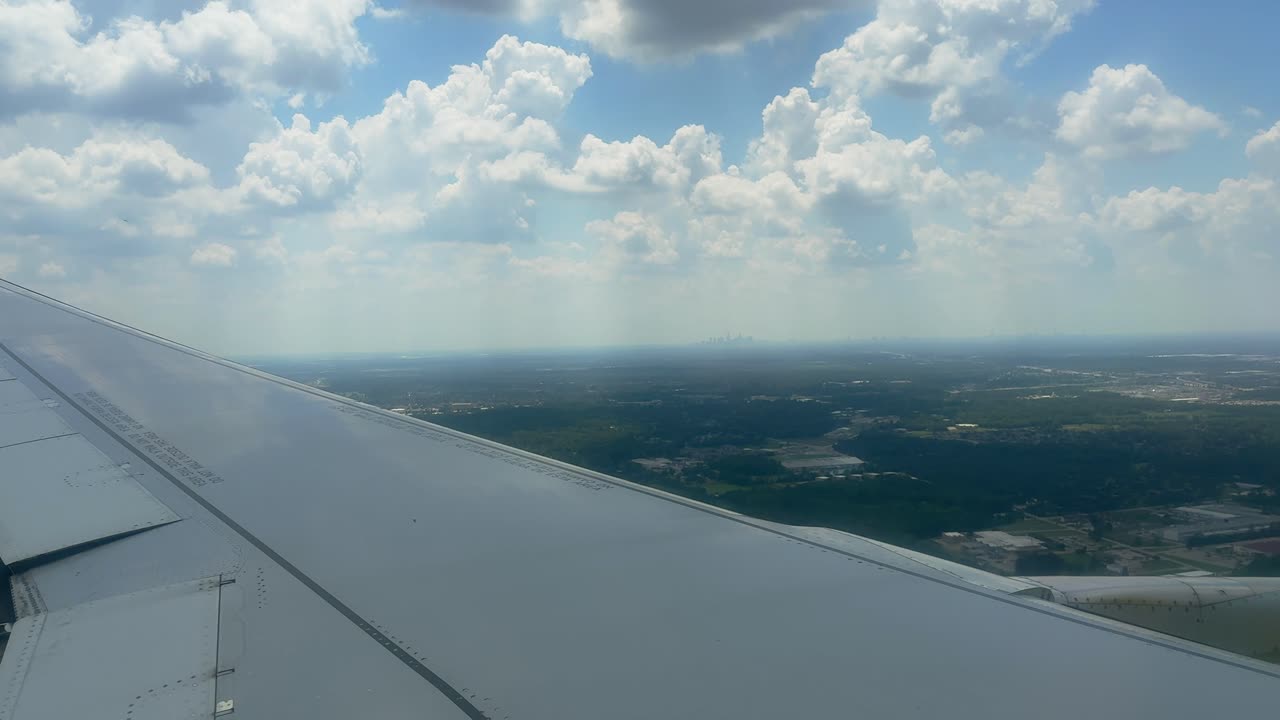Traveling by Air: Looking Out Plane Window at White Cumulus Clouds