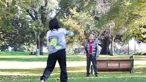 two people playing badminton in the park