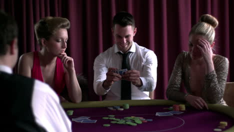 joyful man winning against two girls