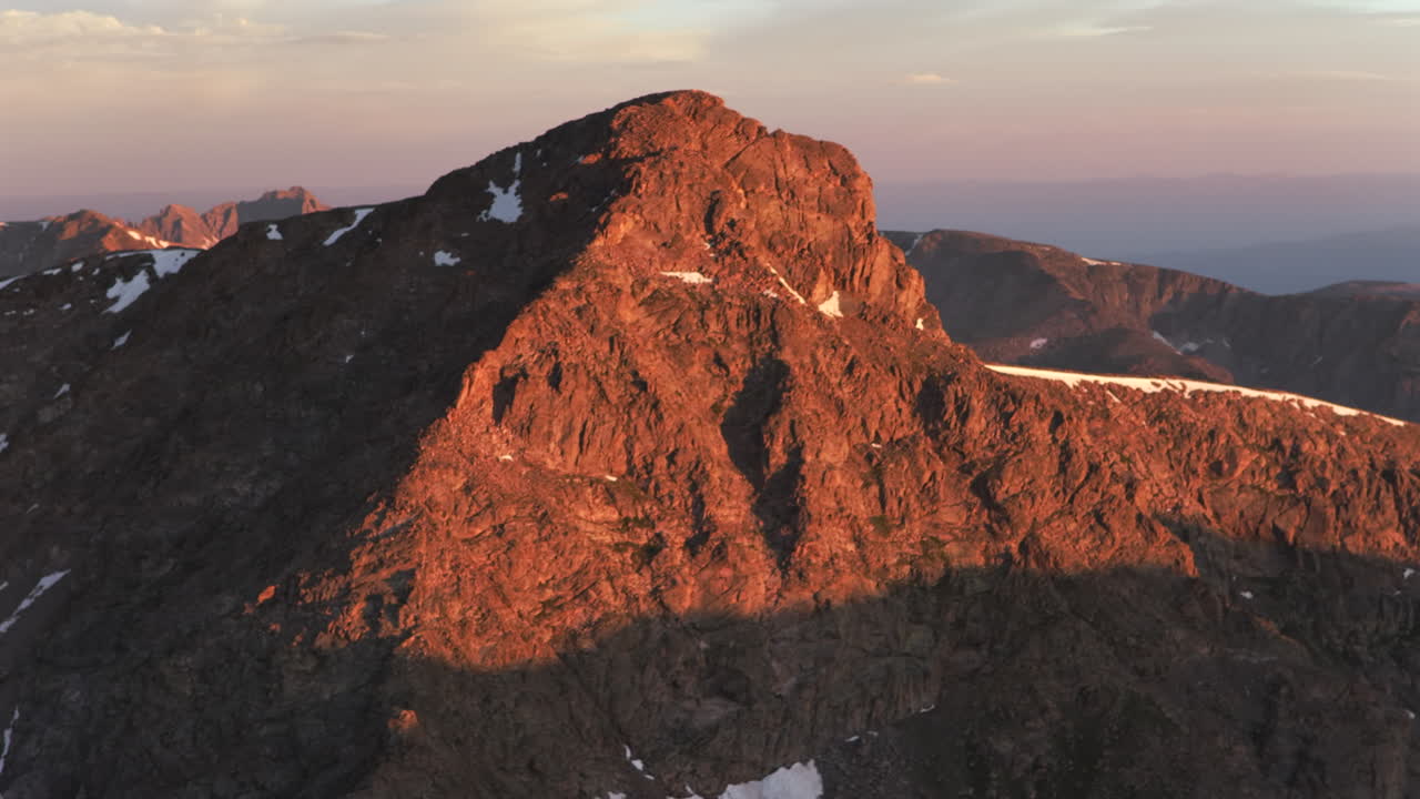 Mount of the Holy Cross 14er peak first light summer morning sunrise aerial drone parallax Sawatch Range Halo Ridge trail shelter Notch Mountain Rocky Mountain snow on summit North ridge circle left