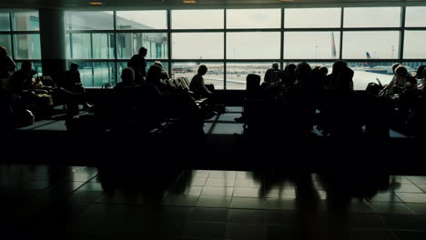 Silhouetted-People-in-Airport-Terminal