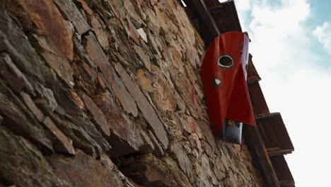 carnival mask adorning stone wall in podence, portugal