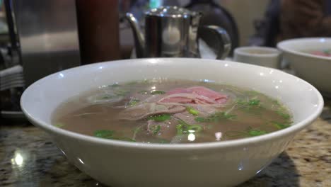 a nice vietnamese soup that seems so delicious on a table