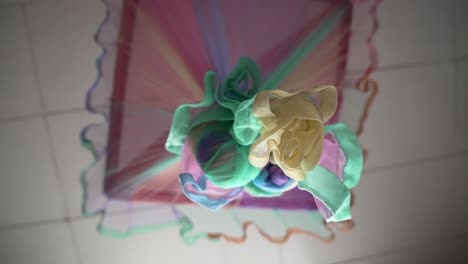 colorful mosquito net arranged in vibrant hues, suspended as a decorative element, viewed from below.