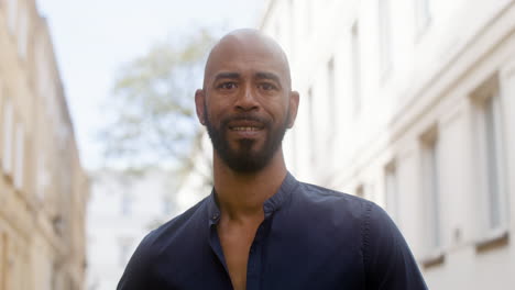 Portrait-Of-An-Afro-Caribeean-Man-Smiling-And-Looking-At-Camera-In-The-Old-Town-Street-1