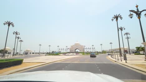 pov from a car driving to the main entrance of presidential palace in abu dhabi, united arab emirates