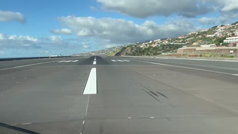 Initial-Take-off-roll-from-Funchal-Airport,-Madeira-Island-,-as-seen-by-the-pilots-in-a-real-time-take-off-runway-23