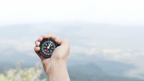 hand holding a compass for travel.