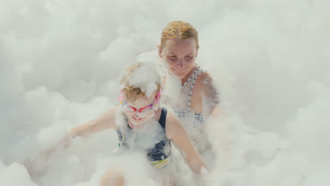 A-Foam-Party-In-A-Resort-Hotel-On-The-Beach-A-Young-Mother-With-Her-Daughter-Having-Fun-In-A-Huge-Am