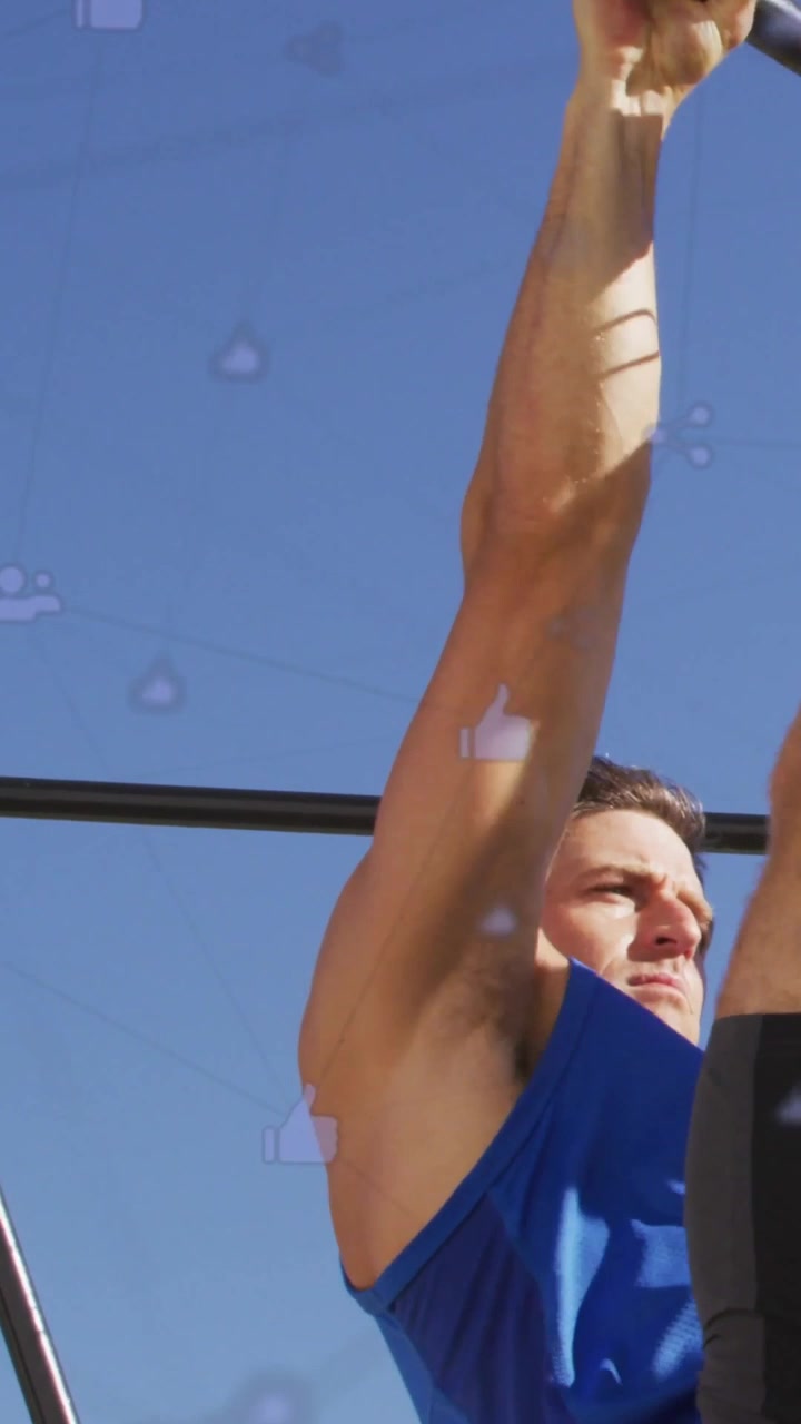 Vertical video: Camera revealing arm, man gripping bar pulling up, promoting fitness icons